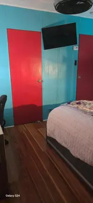 a bedroom with red and blue walls and a bed at Choice of comfort in Hemet