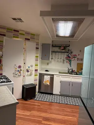 a kitchen with white cabinets and a counter top at Choice of comfort in Hemet