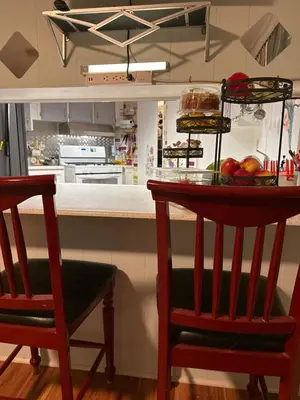 a kitchen with two chairs and a counter with fruit on it at Choice of comfort in Hemet