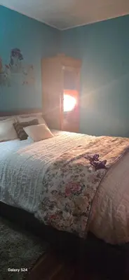 a bedroom with a large bed with a window at Choice of comfort in Hemet