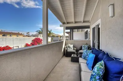 a couch on a balcony with a view of the ocean at Near Beach, Harbor & Ferry Bikes Patio BBQ in Newport Beach