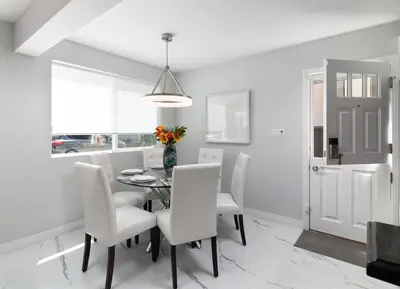 a dining room with a table and white chairs at Balboa Peninsula Beach House Fireplace Bikes in Newport Beach