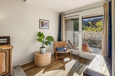 a living room with a chair and a potted plant at Coastal View at Torrey Pines townhouse in San Diego