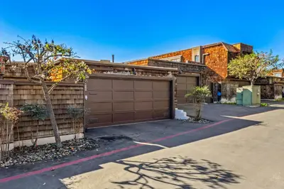 a house with a garage and a fence at Coastal View at Torrey Pines townhouse in San Diego