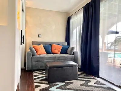 a living room with a couch and a window at Private Bedroom & Bathroom Grove, Pool & City View in Oceanside
