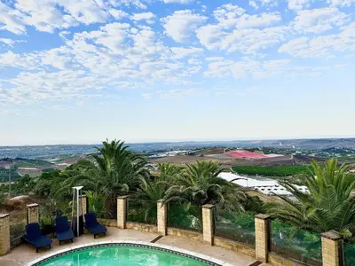 a swimming pool with blue chairs and palm trees at Private Bedroom & Bathroom Grove, Pool & City View in Oceanside