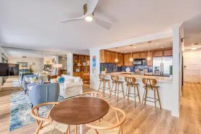 a kitchen and living room with a table and chairs at Ocean Harbor View Dana Point in Dana Point