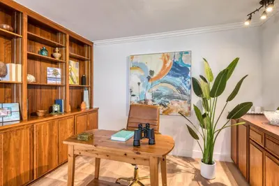 a room with a wooden table and a potted plant at Ocean Harbor View Dana Point in Dana Point