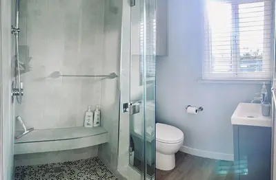 a bathroom with a shower and a toilet and a sink at Stunning Ocean Beach Gem - has everything! in San Diego
