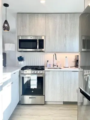 a kitchen with a stove and a microwave at Stunning Ocean Beach Gem - has everything! in San Diego