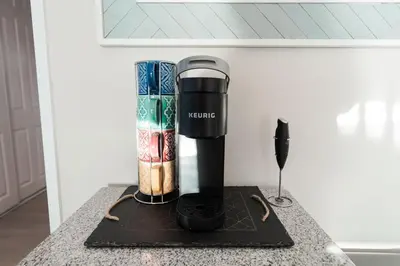 a coffee maker sitting on a counter with books at Beachfront Home In Carlsbad - Remodeled in Carlsbad