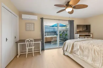 a bedroom with a bed and a desk and a television at Beachfront Home In Carlsbad - Remodeled in Carlsbad