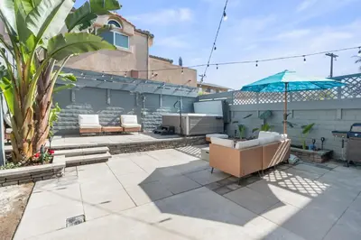 a patio with two chairs and an umbrella at Beachfront Home In Carlsbad - Remodeled in Carlsbad