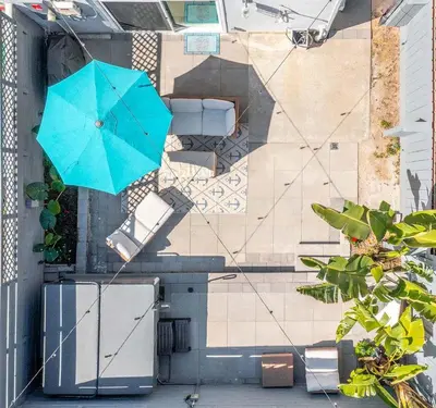 a blue umbrella sitting on top of a house at Beachfront Home In Carlsbad - Remodeled in Carlsbad