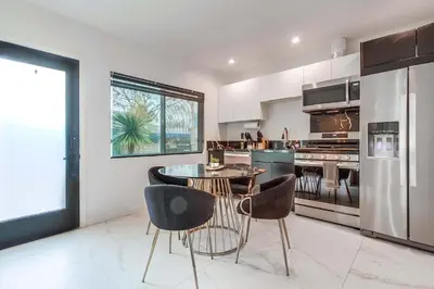 a kitchen with a table and chairs in it at 3 blocks to ocean luxury patio nightlife in San Diego