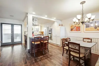 a kitchen and dining room with a table and chairs at SurfSong Dream - Beachfront in Solana Beach