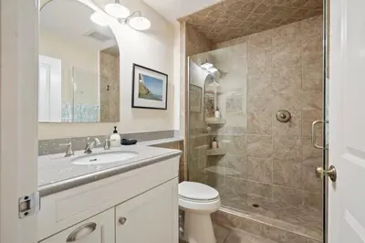 a bathroom with a toilet and a sink and a shower at SurfSong Dream - Beachfront in Solana Beach