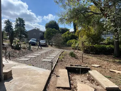 a garden with rocks and trees and a house at The Grove Studio at Mt Helix in La Mesa
