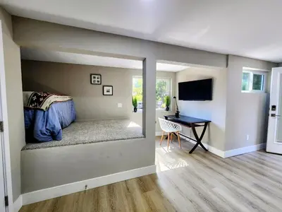 a bedroom with a bed and a desk in a room at The Grove Studio at Mt Helix in La Mesa