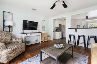 a living room with a couch and a table at O-Side Beach Bungalow with Jaccuzi Blocks to beach in Oceanside