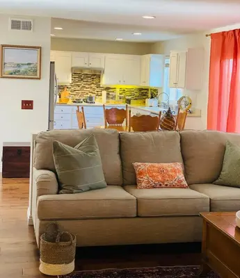 a living room with a couch and a kitchen at 4Bd Spacious Oasis near wineries in Menifee