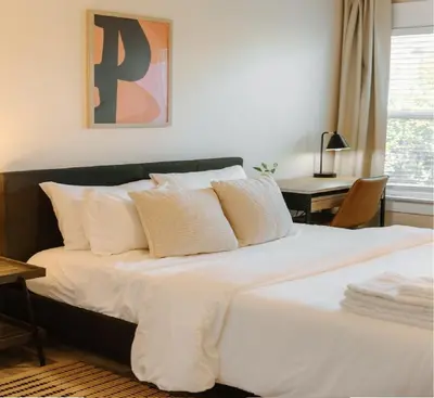 a bed with white sheets and pillows in a bedroom at Outsite San Diego - Golden Hill in San Diego