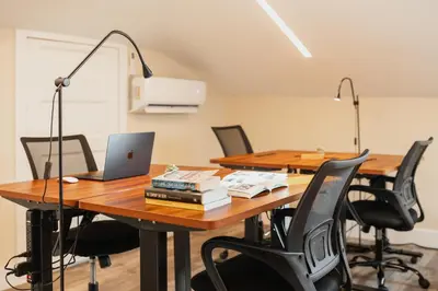 a conference room with a table with a laptop and chairs at Outsite San Diego - Golden Hill in San Diego
