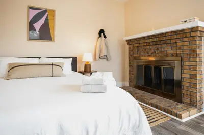 a bedroom with a bed and a fireplace at Outsite San Diego - Golden Hill in San Diego