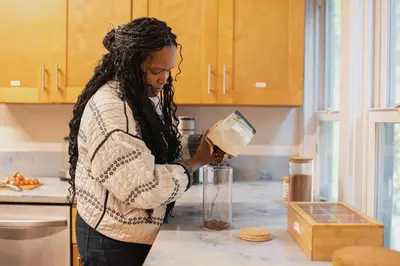 a woman standing in a kitchen preparing food at Outsite San Diego - Golden Hill in San Diego