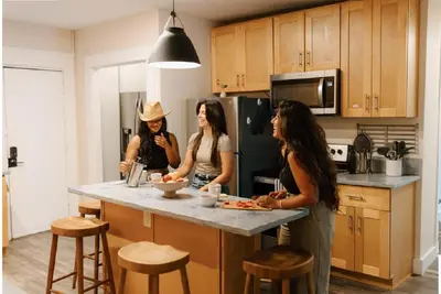 three women standing in a kitchen preparing food at Outsite San Diego - Golden Hill in San Diego
