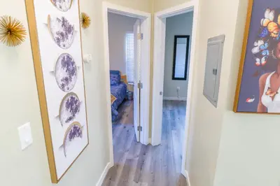 a room with a hallway with a mirror and a room with a hallway at 2BR Retreat Near Balboa Park in San Diego
