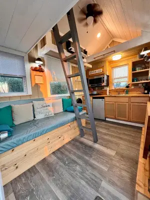 a living room with a bunk bed in a tiny house at Tiny House on private large property in Vista