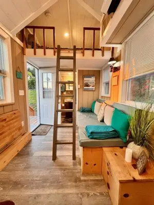 a tiny house with a bunk bed and a couch at Tiny House on private large property in Vista