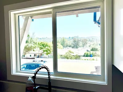 a kitchen window with a view of a car at Exotic home Rogers road in Spring Valley