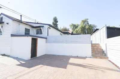 a house with a white fence and a driveway at Exotic home Rogers road in Spring Valley