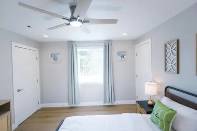 a bedroom with a bed and a ceiling fan at Exotic home Rogers road in Spring Valley