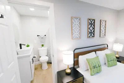 a bedroom with a bed with green and white pillows at Exotic home Rogers road in Spring Valley
