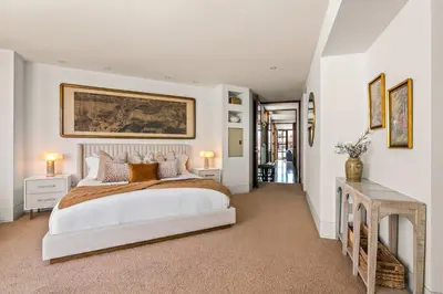 a bedroom with a bed and a painting on the wall at Brand New Listing Elegant 7BR Masterpiece Walk to Beach Shops & Dining in San Diego