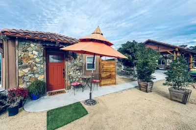 a house with a red door and an umbrella at Backyard and Zen Garden Hilltop Haven in Bonsall! in Vista