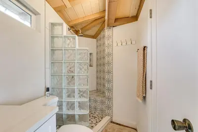 a bathroom with a shower and a toilet at Backyard and Zen Garden Hilltop Haven in Bonsall! in Vista