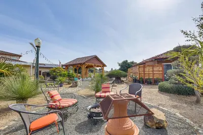 a patio with chairs and a grill and a house at Backyard and Zen Garden Hilltop Haven in Bonsall! in Vista