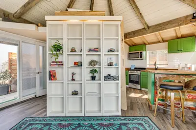 a kitchen with green cabinets and a white book shelf at Backyard and Zen Garden Hilltop Haven in Bonsall! in Vista