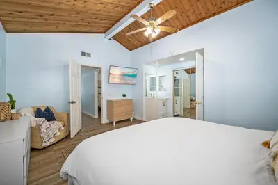 a bedroom with a bed and a ceiling fan at 3BR Home Steps from Shops, Pier and Beach in Newport Beach