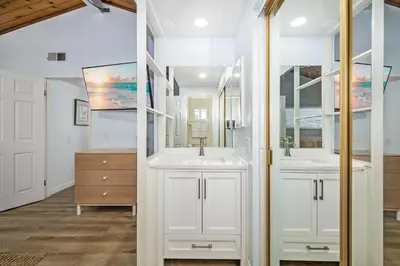 a bathroom with two sinks and a mirror at 3BR Home Steps from Shops, Pier and Beach in Newport Beach