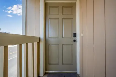 a door on the side of a building at 3BR Home Steps from Shops, Pier and Beach in Newport Beach