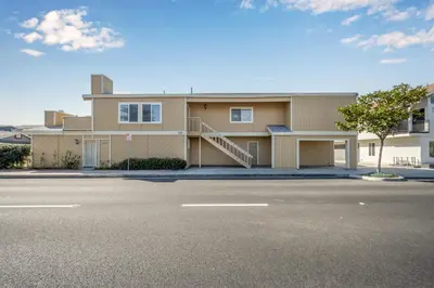 a large house with a road in front of it at 3BR Home Steps from Shops, Pier and Beach in Newport Beach