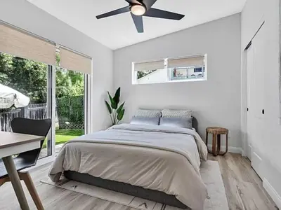 a bedroom with a bed and a ceiling fan at The Quaint Cardiff Hideaway with Pak N Play in Encinitas