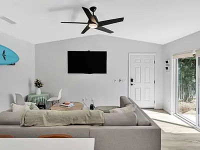 a living room with a couch and a ceiling fan at The Quaint Cardiff Hideaway with Pak N Play in Encinitas