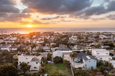 an aerial view of a residential neighborhood with a sunset at ENC-1035 - Charming Coastal Cottage in Encinitas