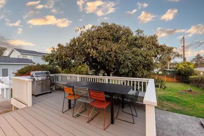 a black table and chairs on a deck at ENC-1035 - Charming Coastal Cottage in Encinitas